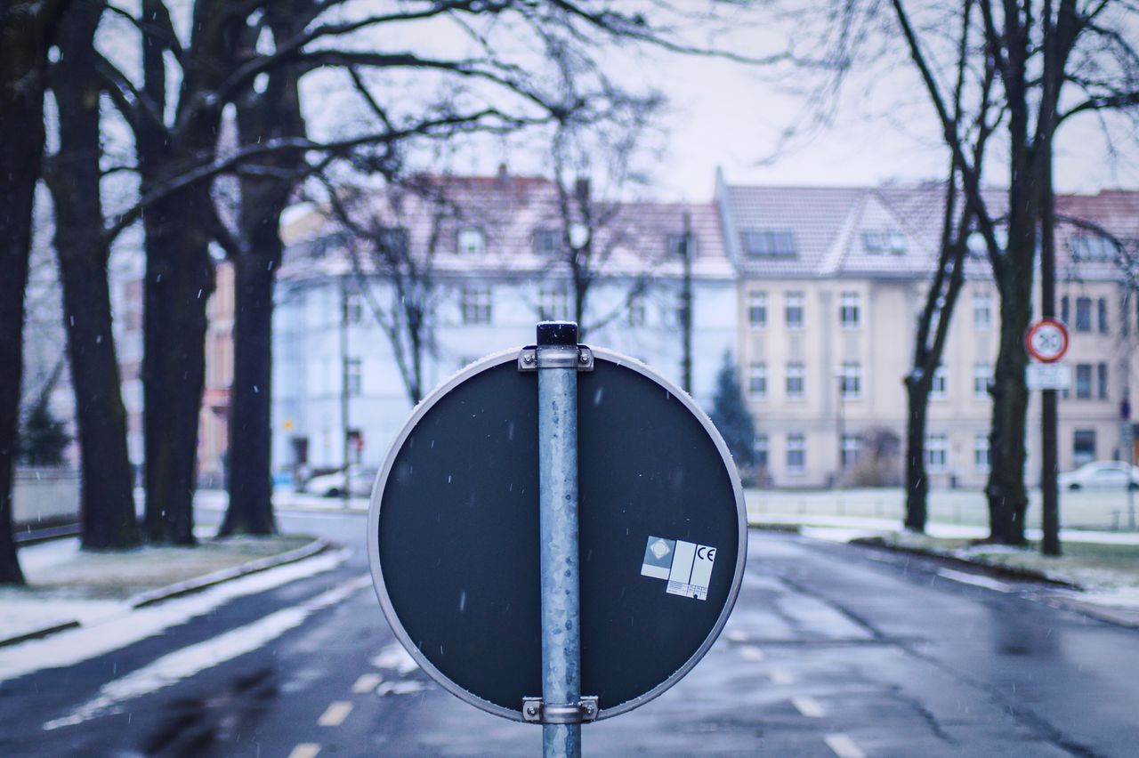 Close-up of road sign against sky