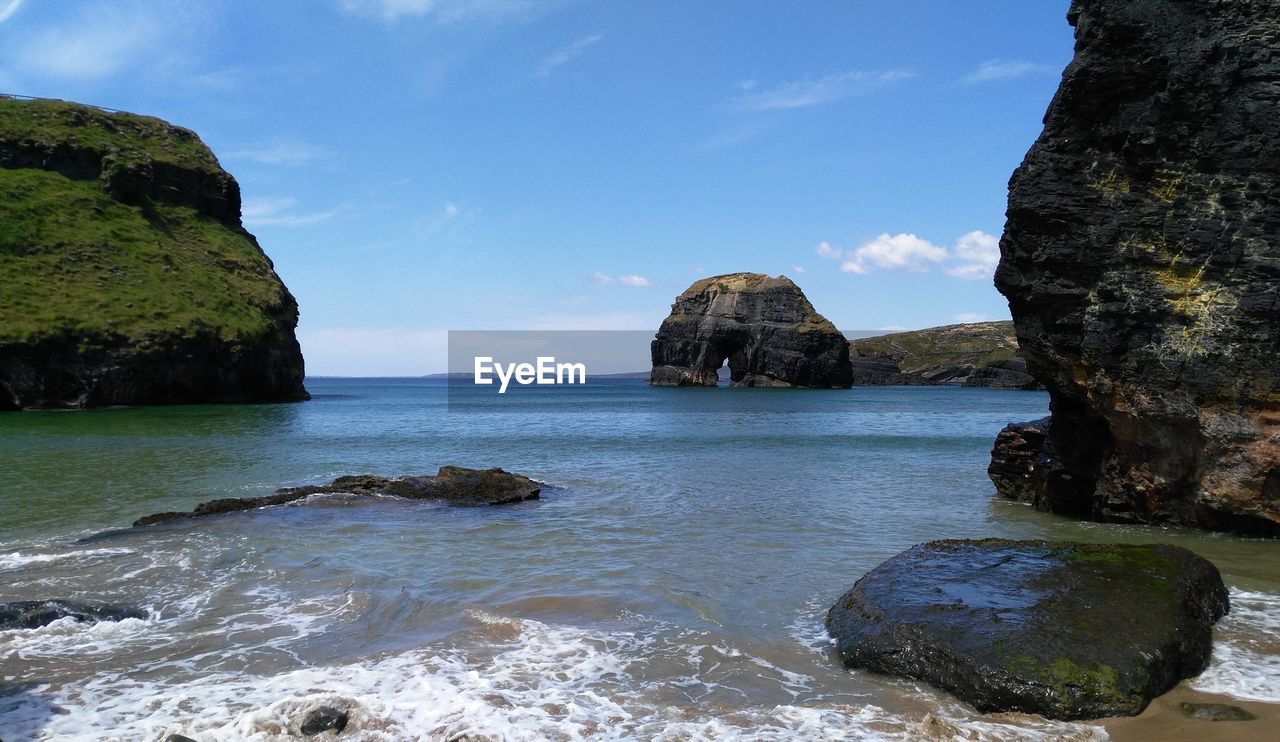 Rocks in sea against sky