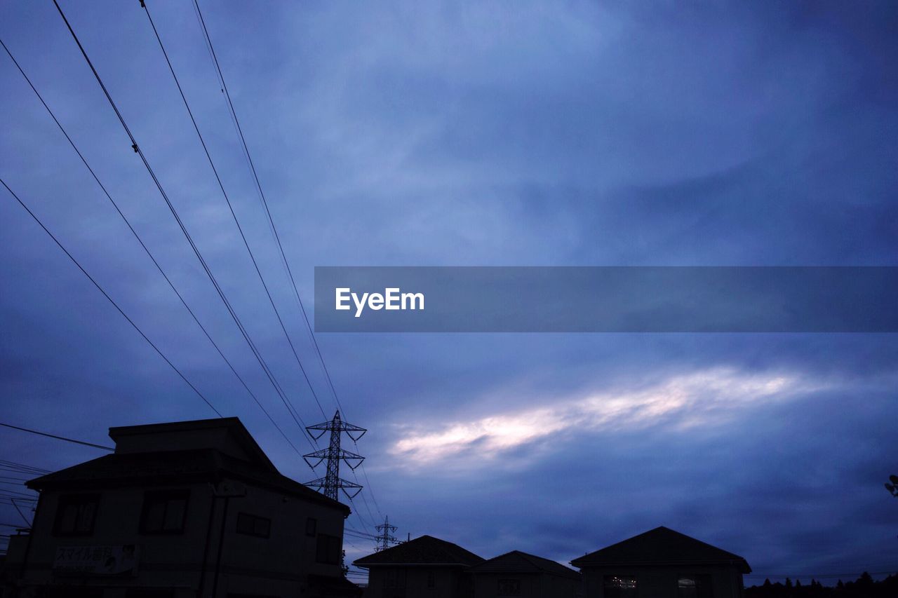 LOW ANGLE VIEW OF ELECTRICITY PYLON IN TOWN