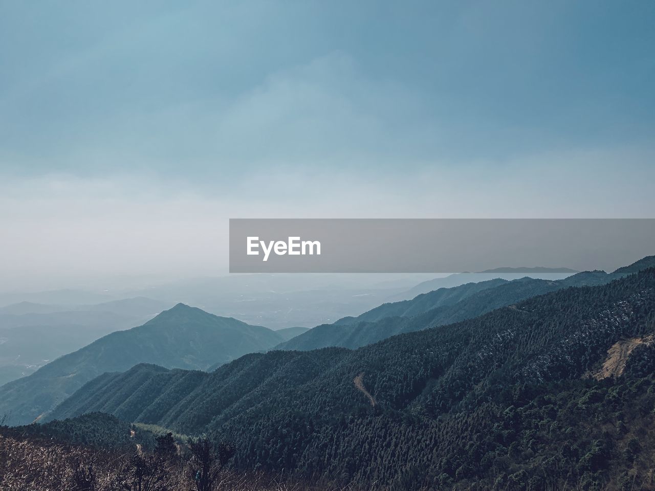 High angle view of mountain range against cloudy sky