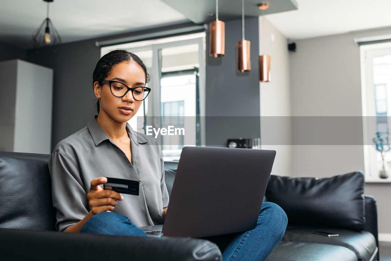 Young woman using mobile phone in office