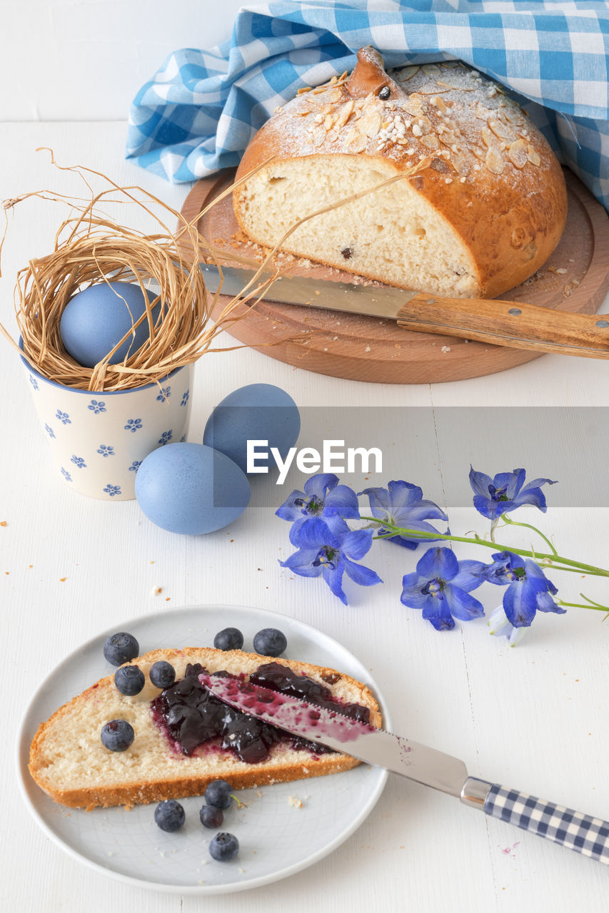 Traditional czech easter food and symbols, pastry mazanec, eggs and pomlazka. 