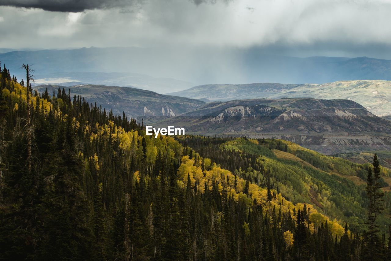 Scenic view of mountains against cloudy sky