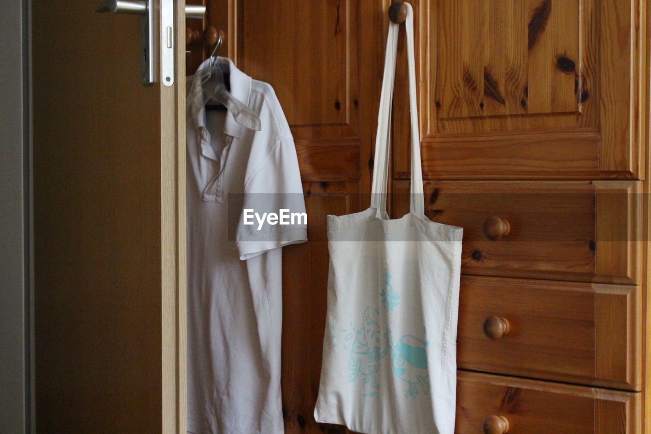 Shopping bag hanging on cabinet at home