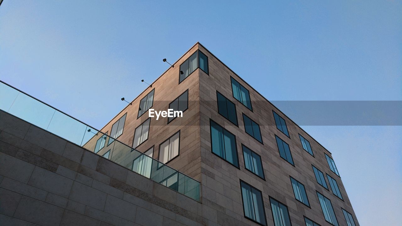 Low angle view of building against clear blue sky