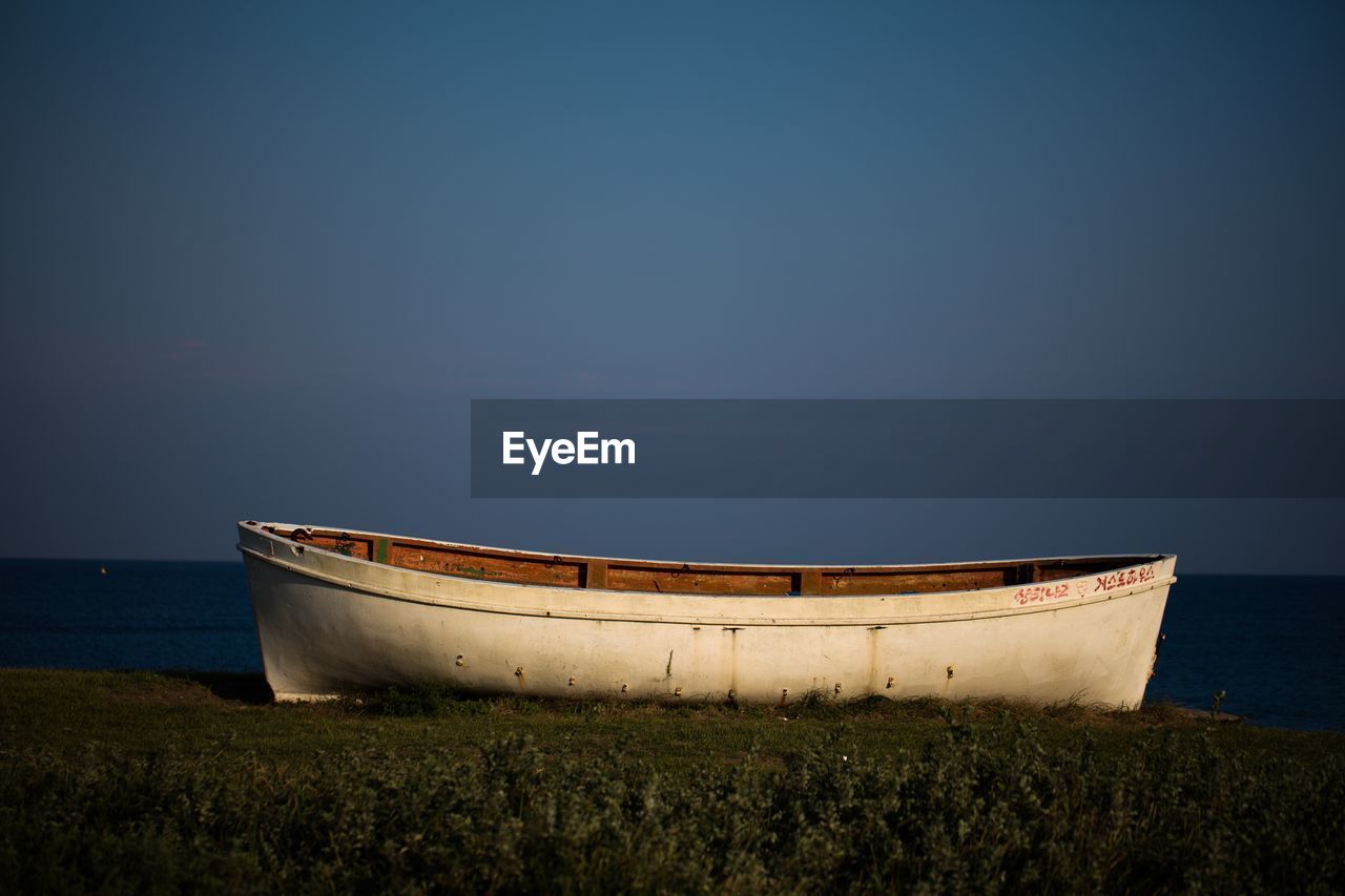 View of boat of cliff by the beach