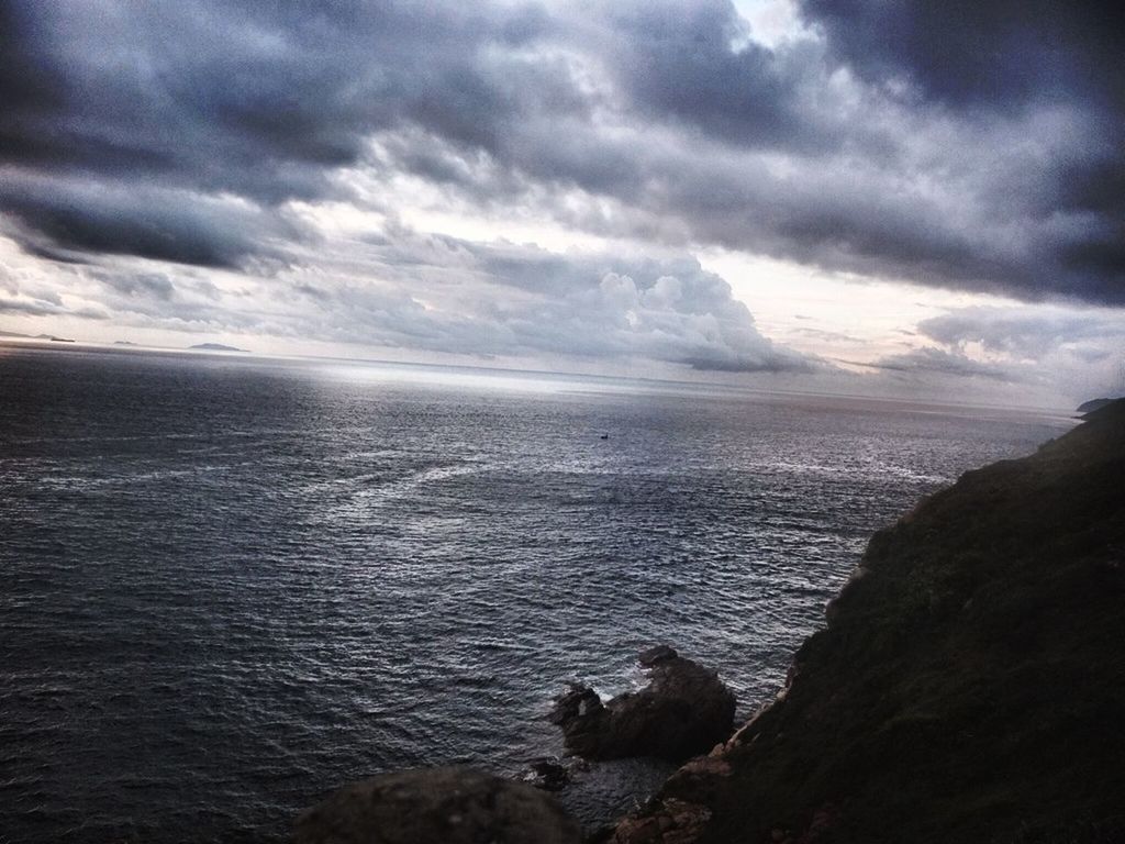 SCENIC VIEW OF SEA WITH MOUNTAIN IN BACKGROUND