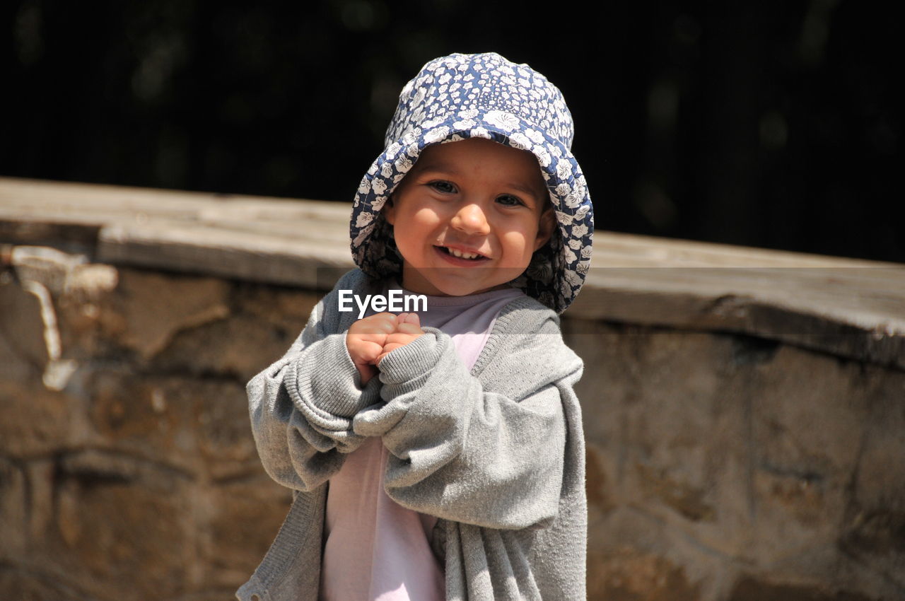 Portrait of young baby woman standing outdoors