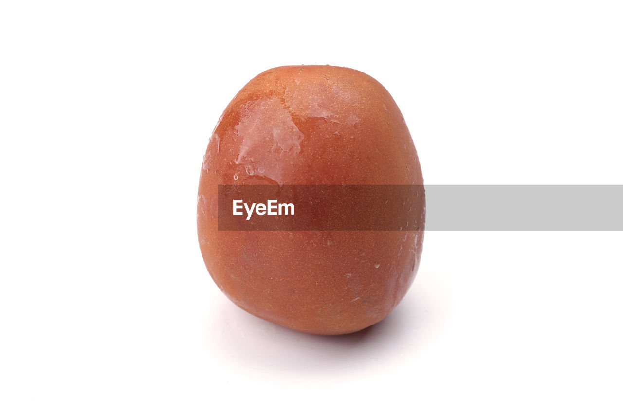 Close-up of tomato against white background