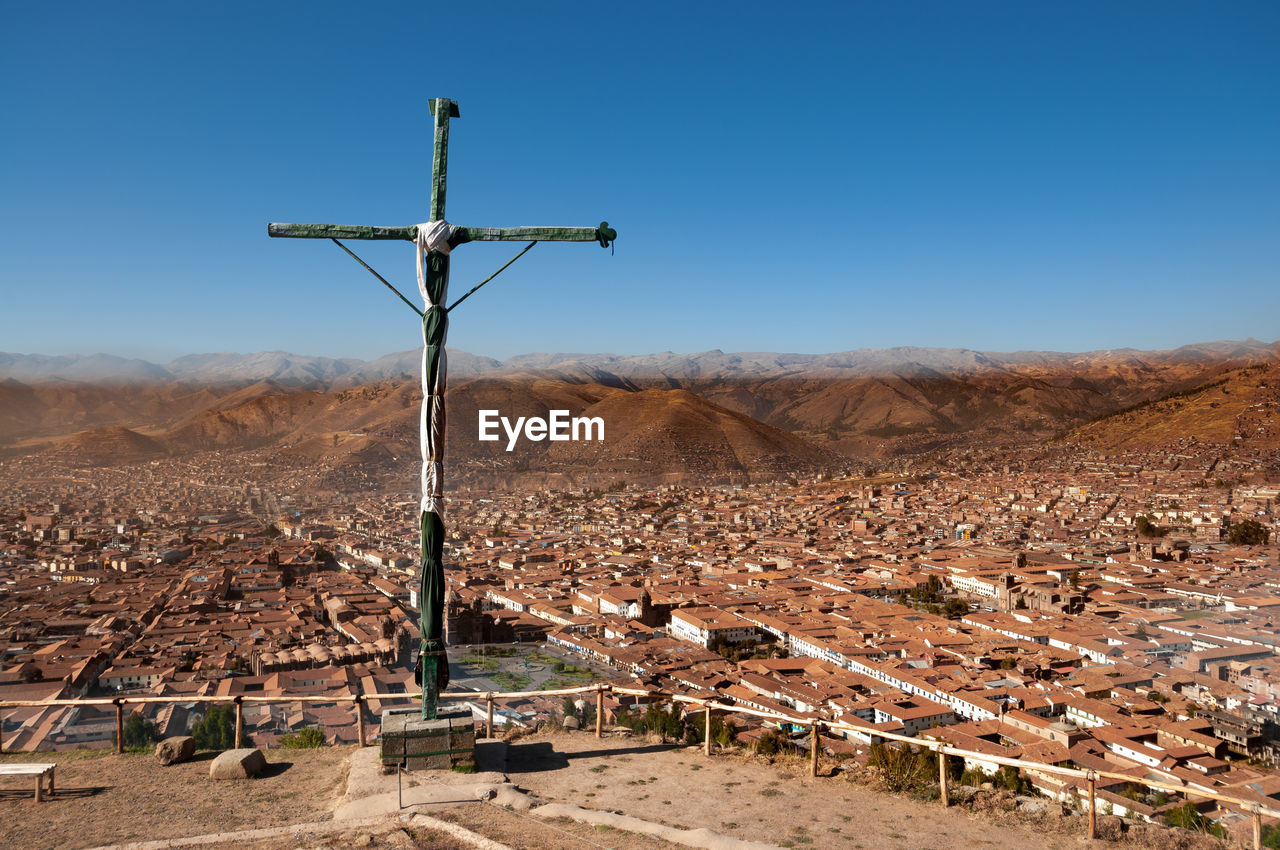 WINDMILLS ON LANDSCAPE AGAINST CLEAR SKY