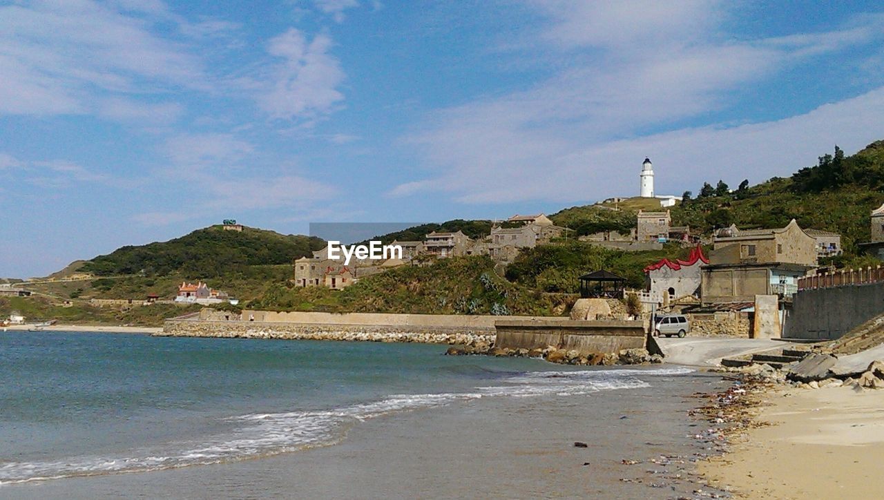 VIEW OF LIGHTHOUSE IN FRONT OF SEA AGAINST SKY