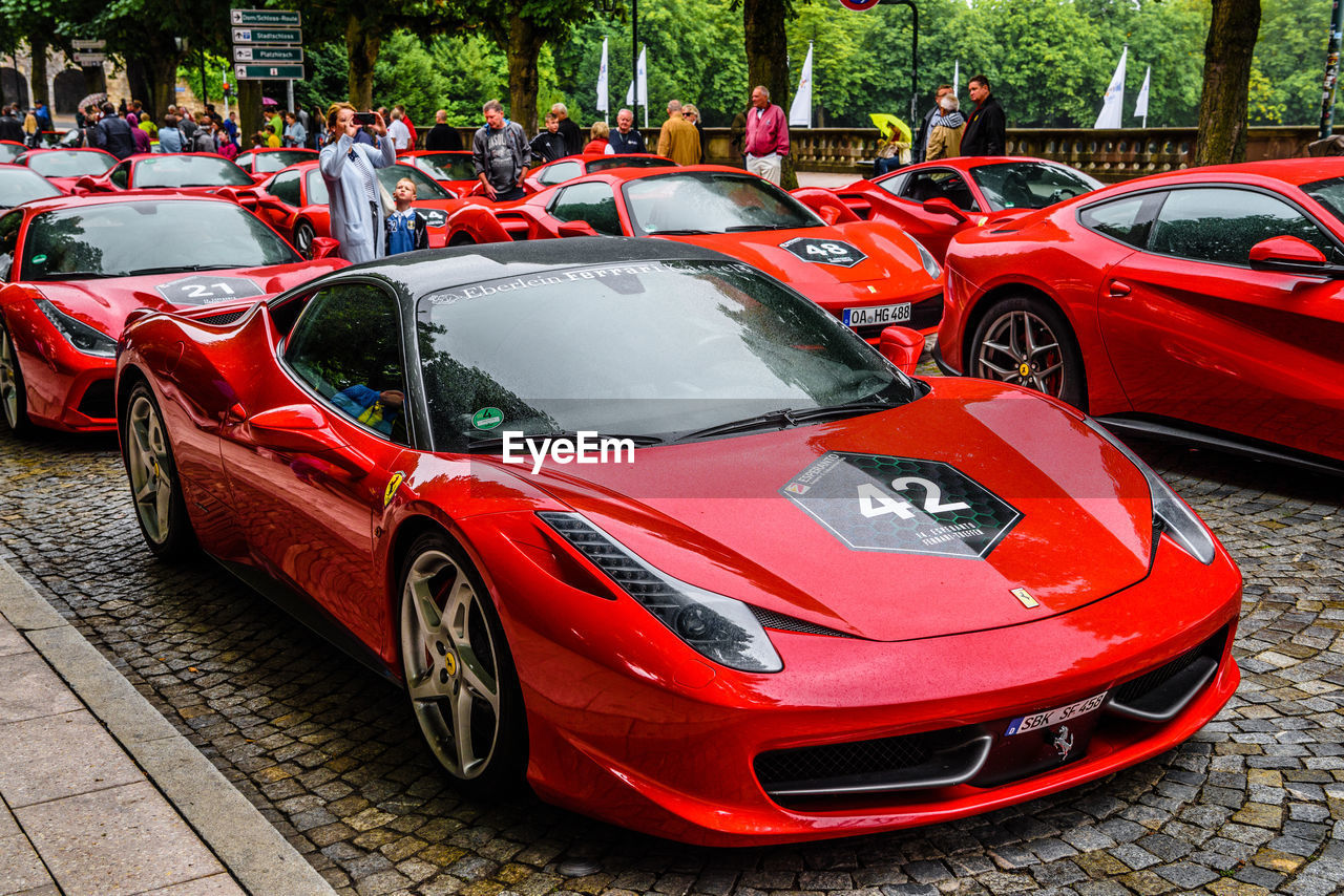 CLOSE-UP OF RED CAR ON STREET