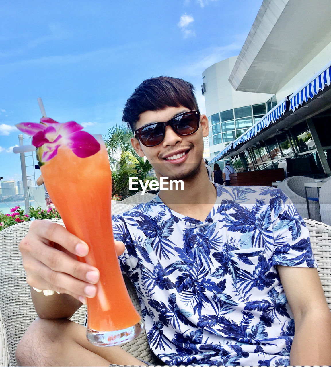 Portrait of smiling man holding cocktail drink