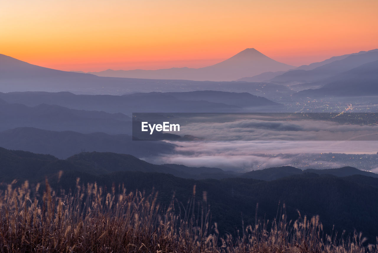 Scenic view of silhouette mountains against sky during sunset