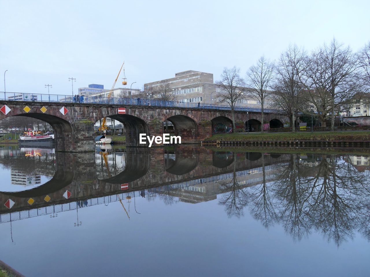 BRIDGE OVER RIVER AGAINST SKY IN CITY