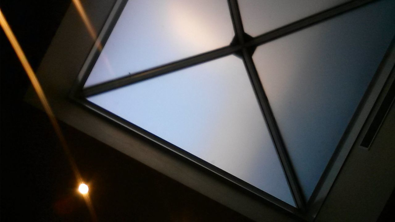 Low angle view of skylight in dark room