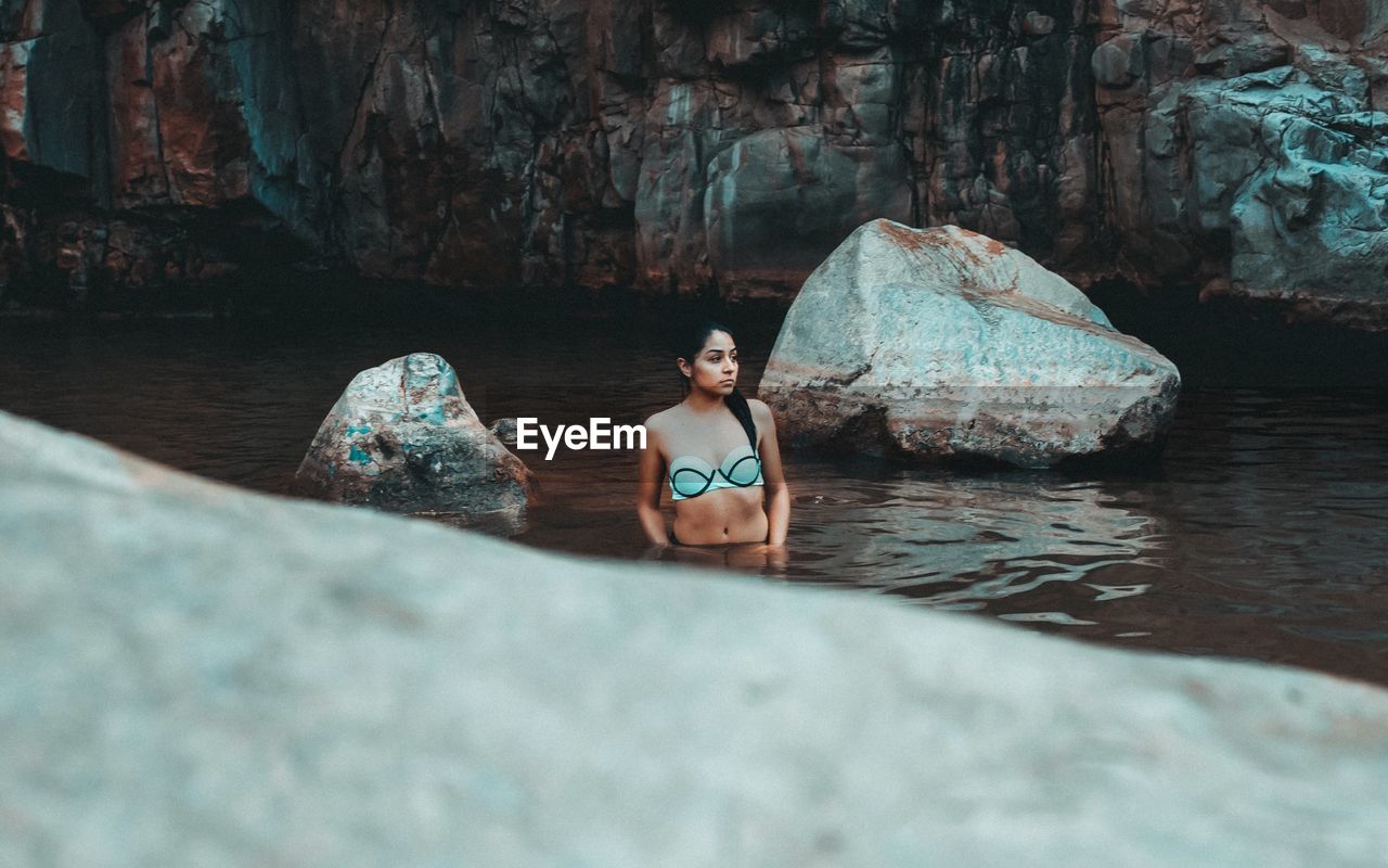 Young woman standing in lake