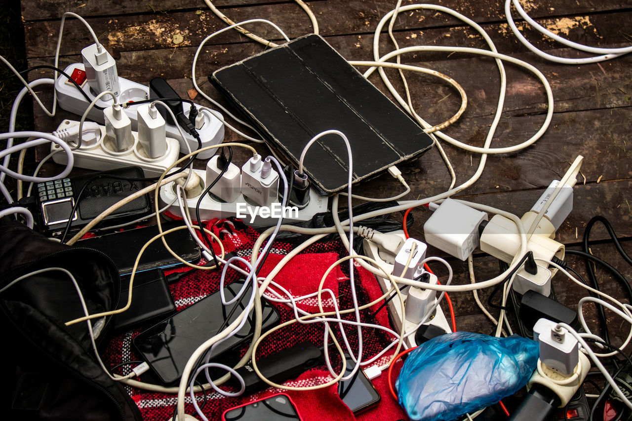 cable, no people, large group of objects, technology, wire, high angle view, messy, electricity, tangled, indoors, still life, metal, complexity, chaos, equipment, music, art, variation