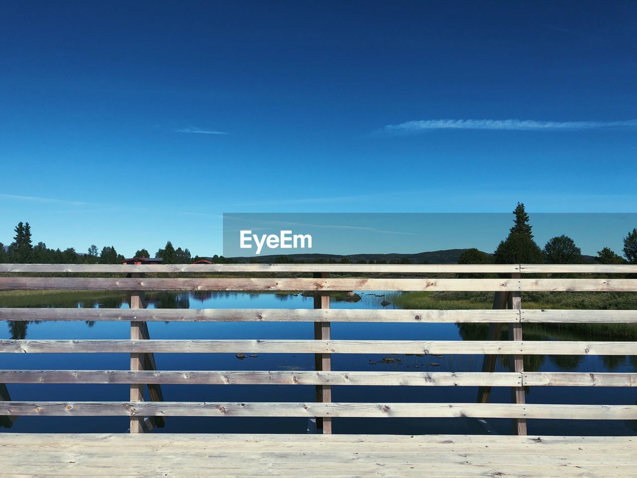 Scenic view of lake against blue sky