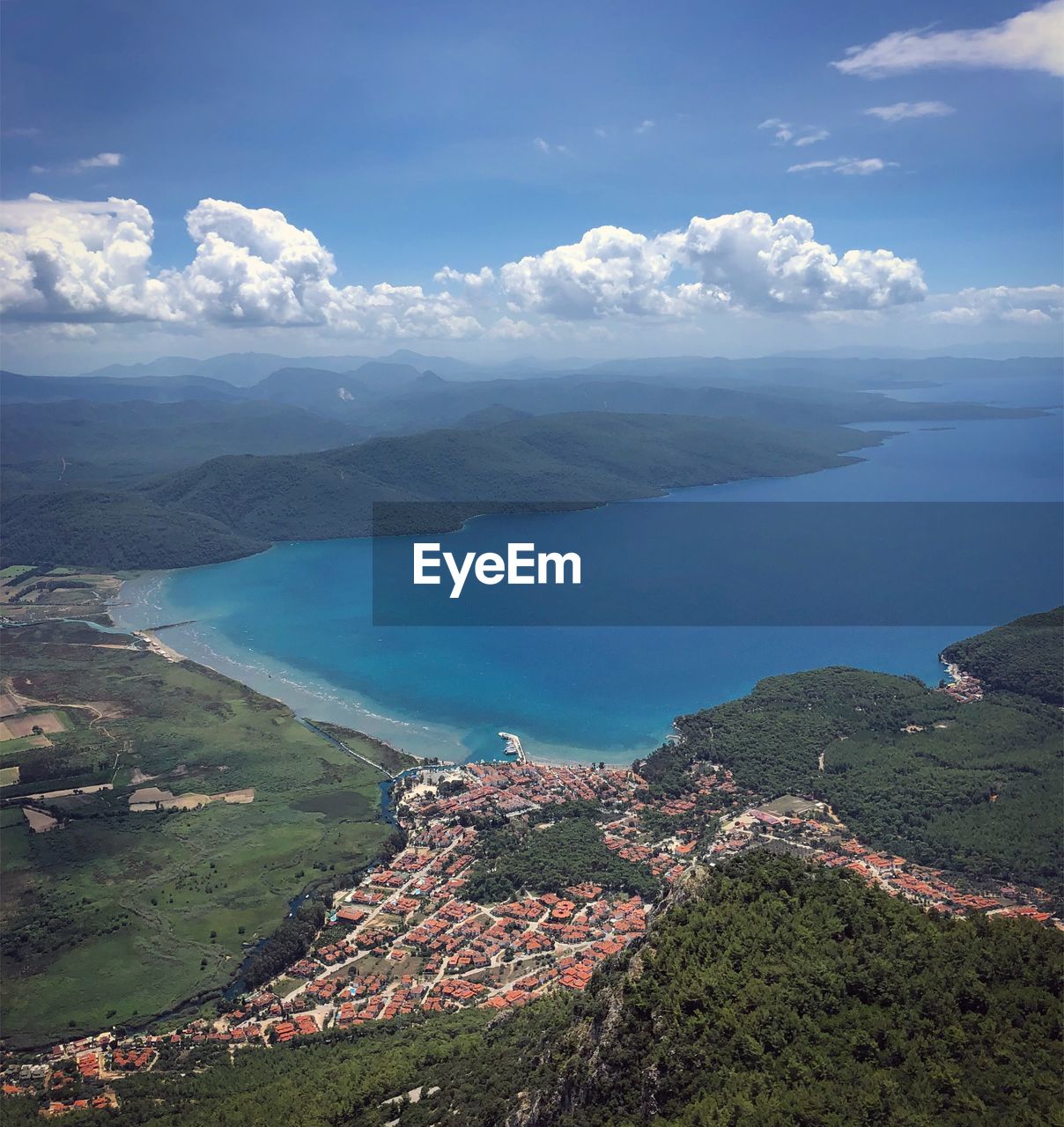 High angle view of sea and mountains against sky