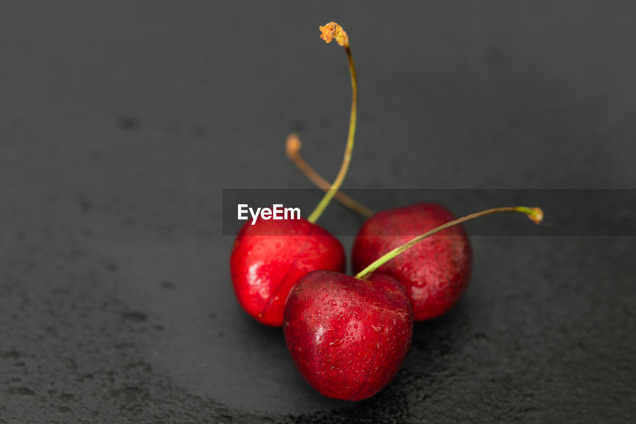 Close-up of strawberries on table against black background