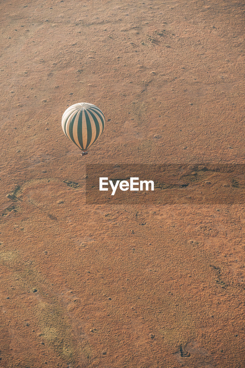 Hot air balloon flying over land