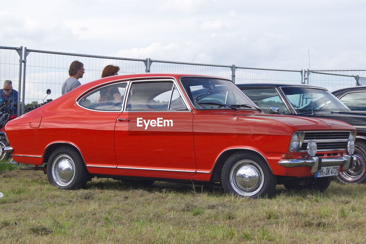 VIEW OF RED CAR ON ROAD