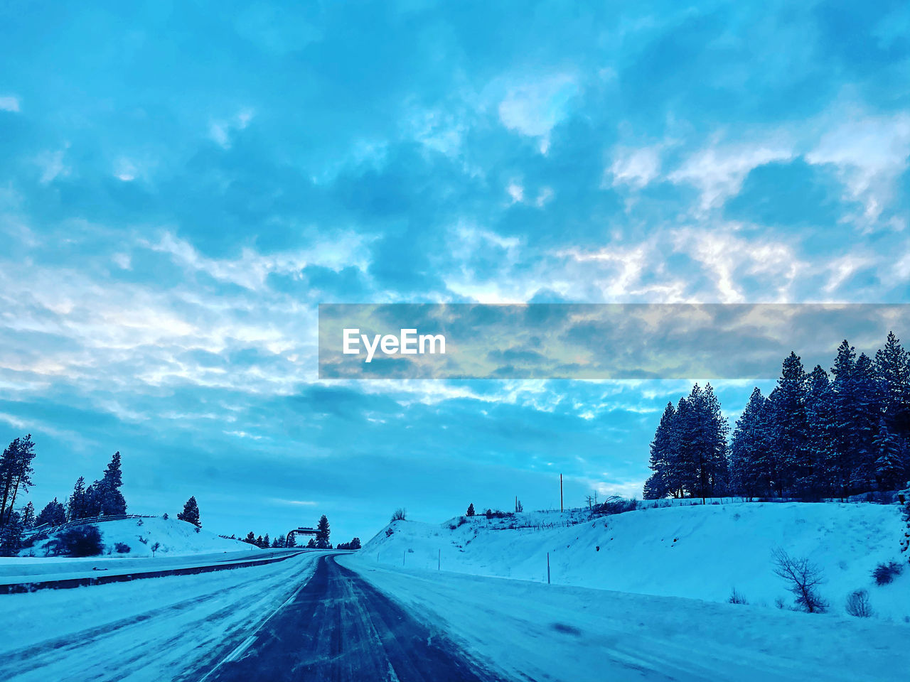 ROAD AMIDST SNOWCAPPED LANDSCAPE AGAINST SKY