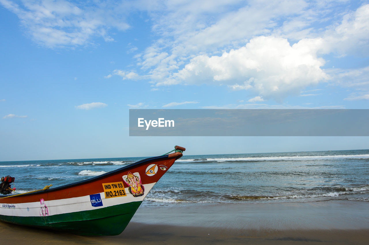 Cropped boat at calm sea against blue sky