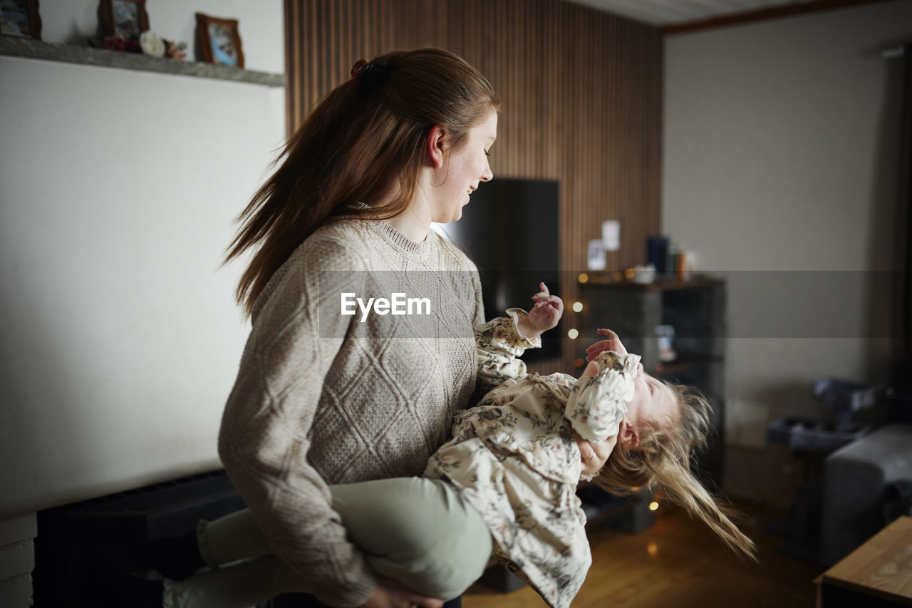 Mother playing with disabled child at home