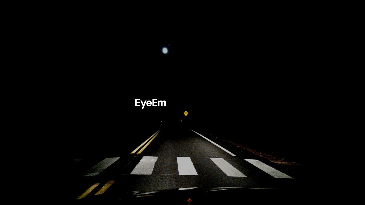 LOW ANGLE VIEW OF ILLUMINATED TUNNEL