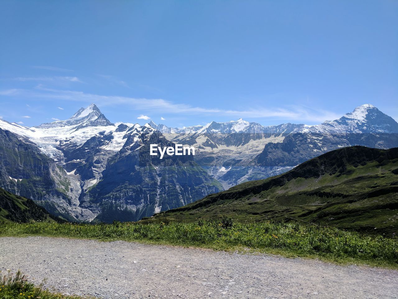 Scenic view of snowcapped mountains against blue sky