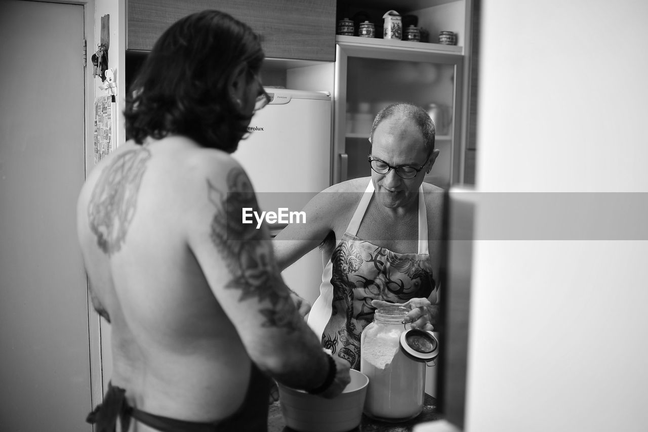 Men preparing food at home