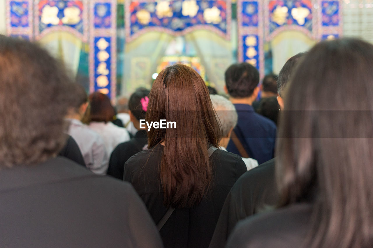 REAR VIEW OF PEOPLE LOOKING AT MUSIC FESTIVAL