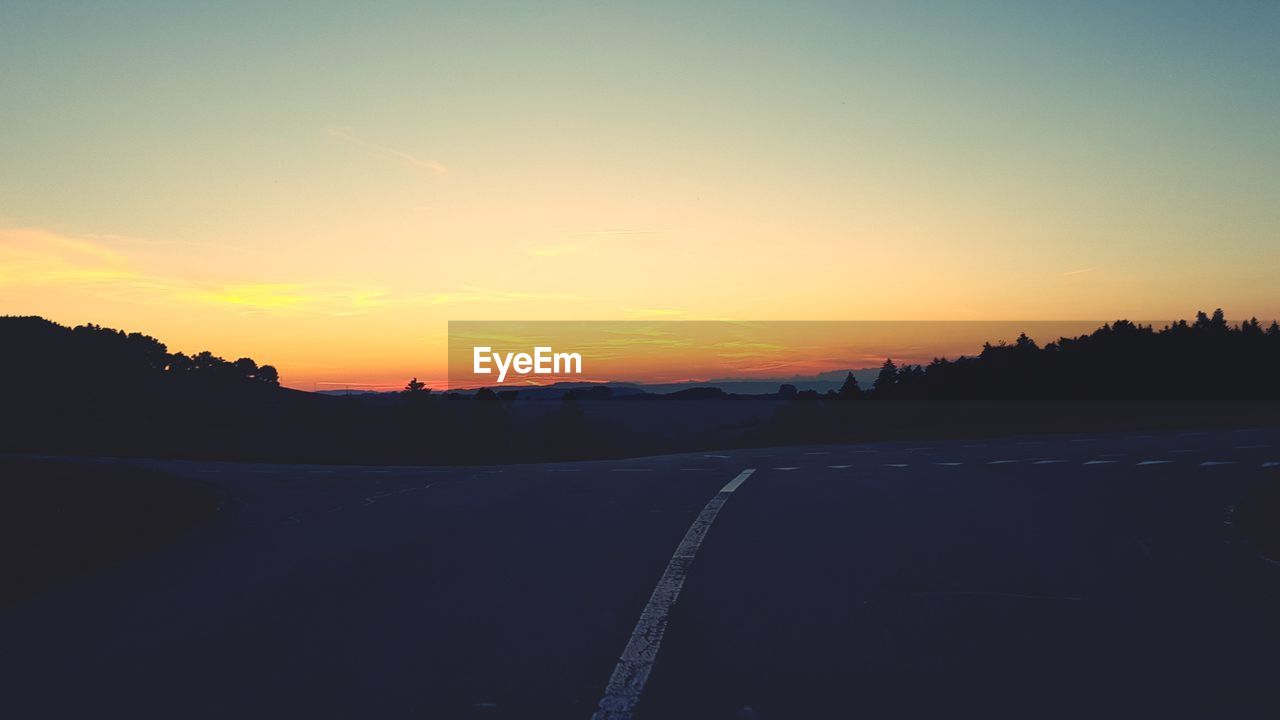 SCENIC VIEW OF SILHOUETTE LANDSCAPE AGAINST ROMANTIC SKY