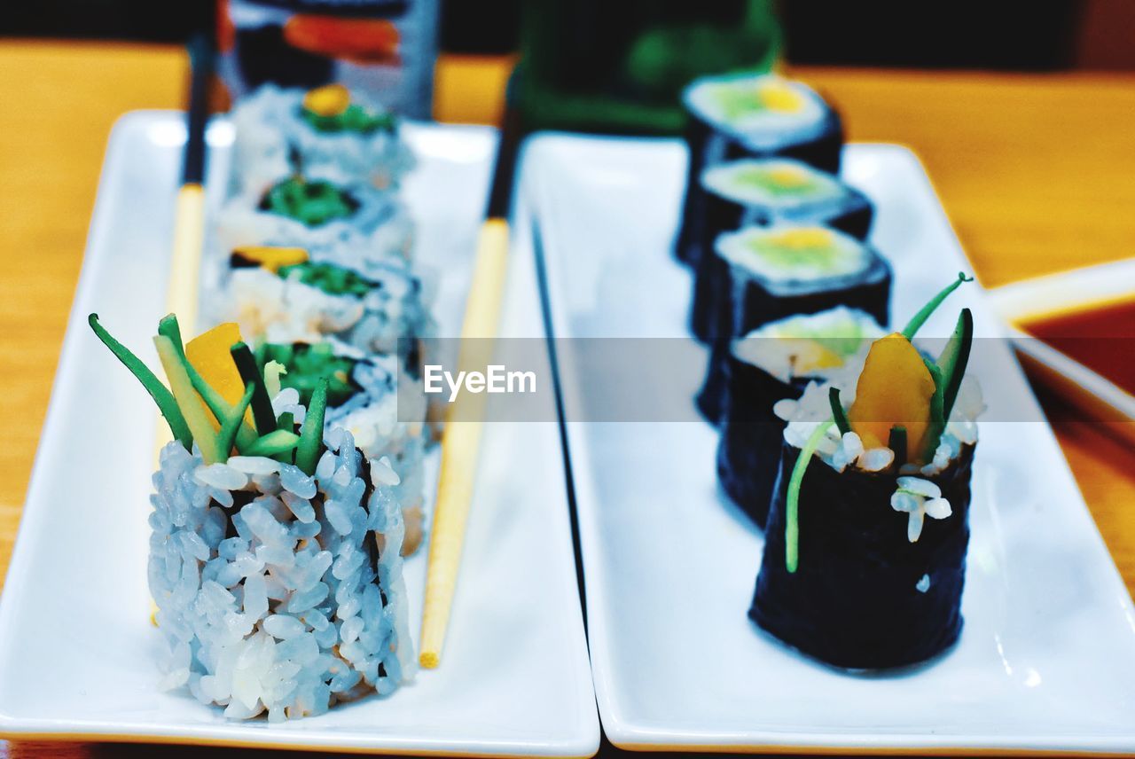 Close-up of sushi served in plates on table