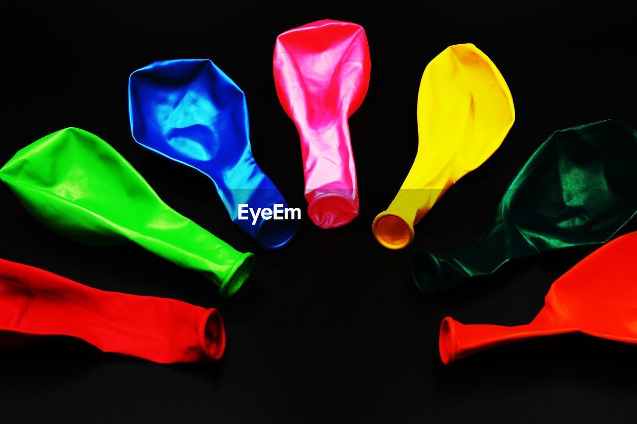 Close-up of multi colored balloons against black background