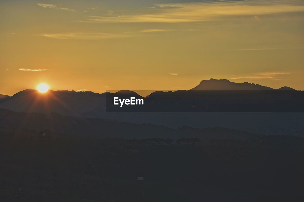 SILHOUETTE MOUNTAINS AGAINST SKY DURING SUNSET