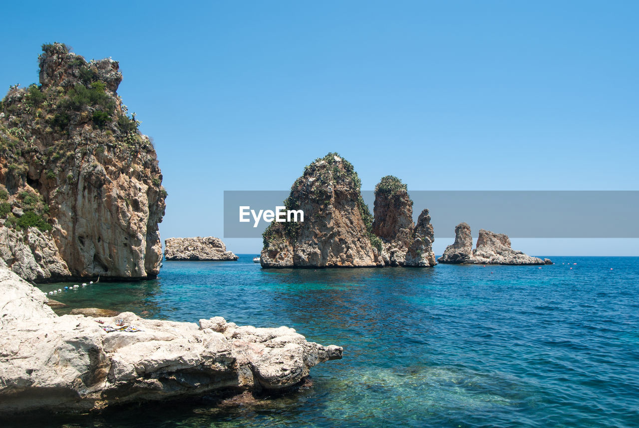 Scenic view of sea against clear blue sky