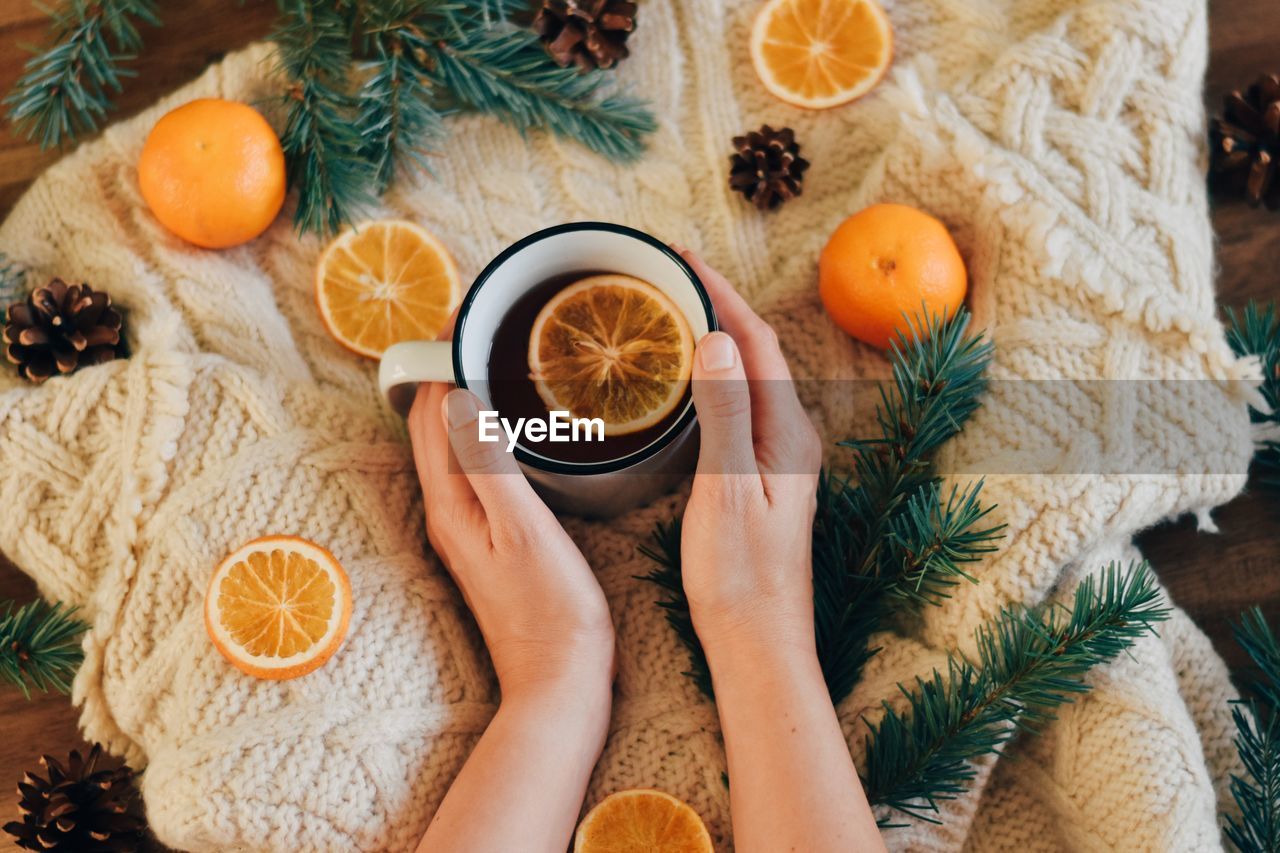 High angle view of woman holding tea cup 