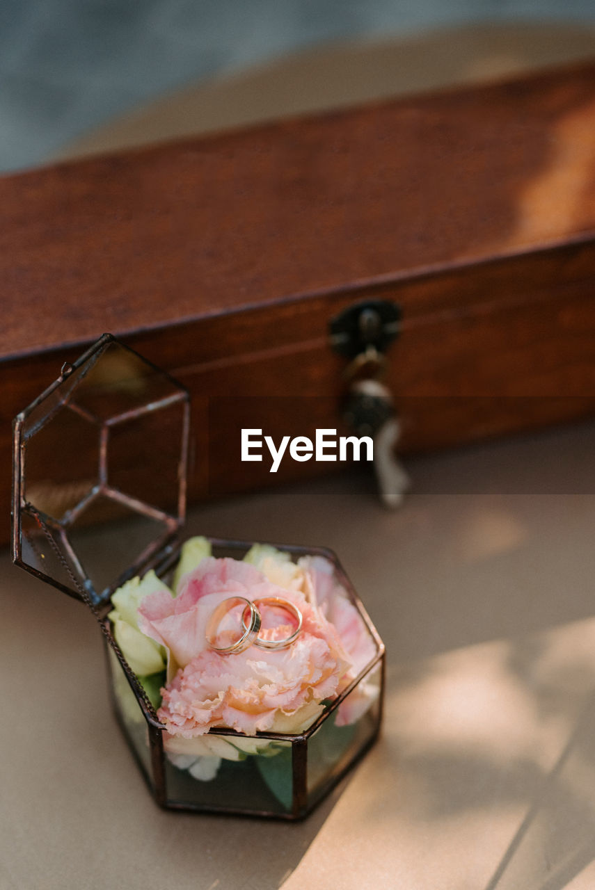 High angle view of rings over flowers in jewelry box