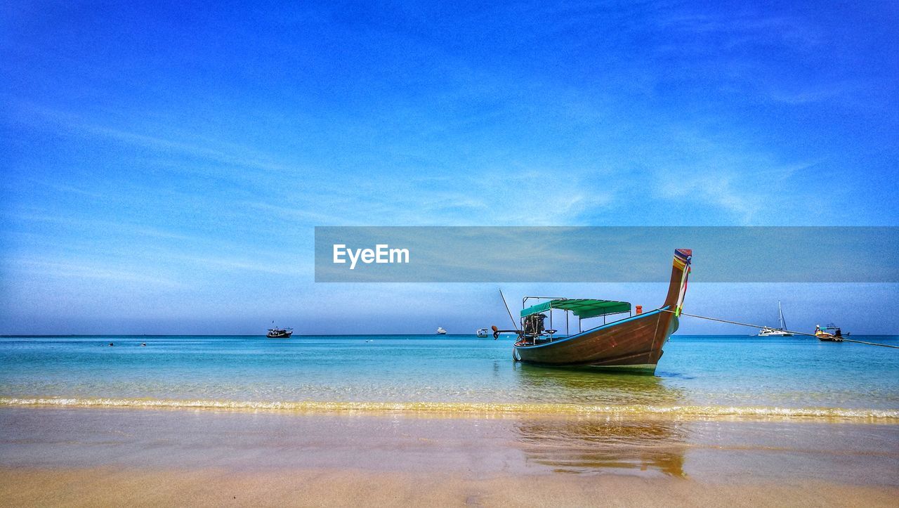 BOATS IN SEA AGAINST CLEAR BLUE SKY