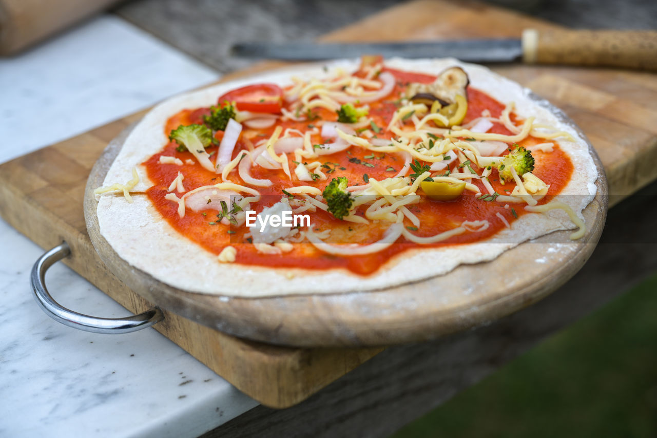 food and drink, food, vegetable, fast food, pizza, freshness, italian food, healthy eating, dish, cheese, dairy, tomato, wood, cuisine, fruit, no people, wellbeing, savory food, herb, meal, spice, produce, basil, condiment, table, close-up, vegetarian food, indoors, sauce, restaurant, onion