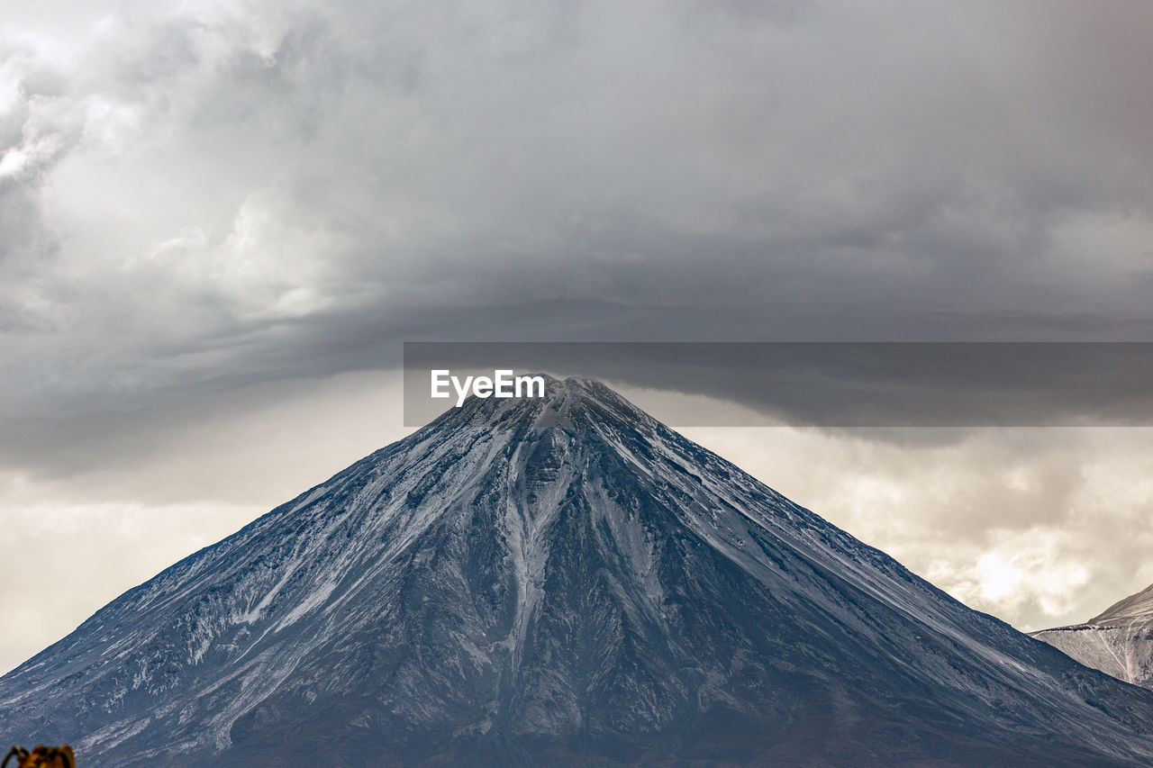 View of snowcapped mountain against cloudy sky