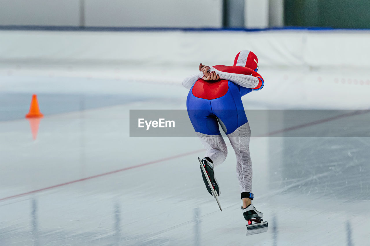 Female athlete speed skater run in ice skating competition