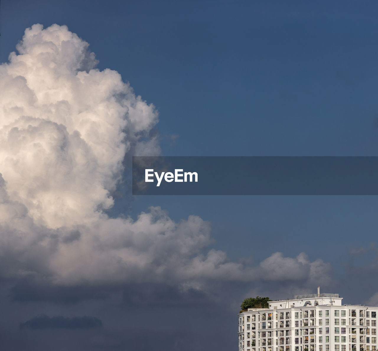 Low angle view of building against cloudy sky