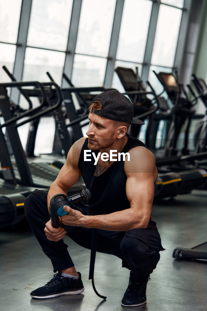 side view of man exercising in gym