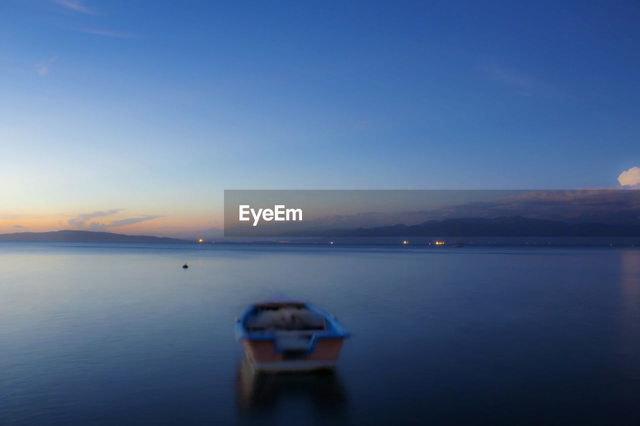 Scenic view of sea against clear sky at sunset