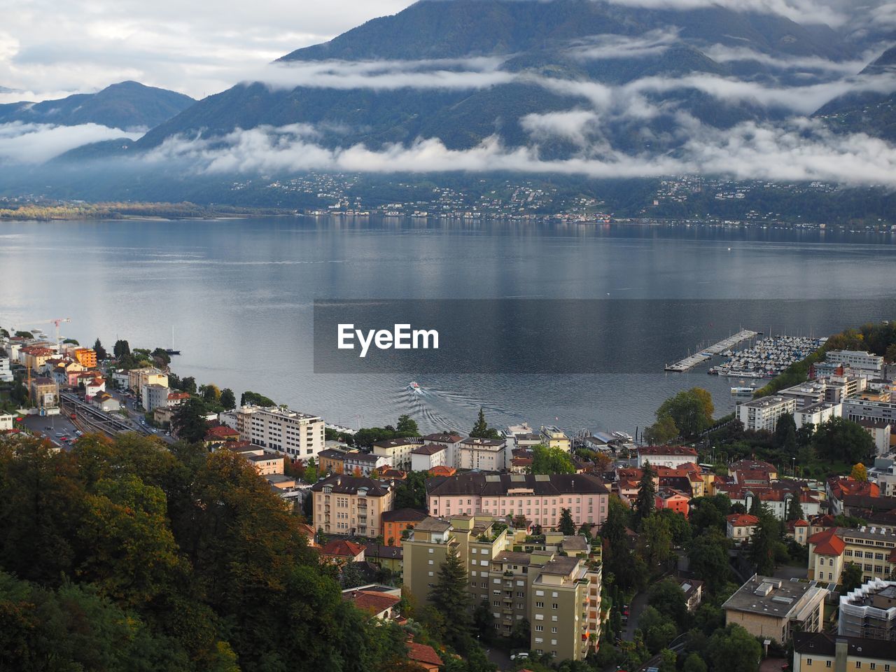 High angle view of town amidst lake by mountain
