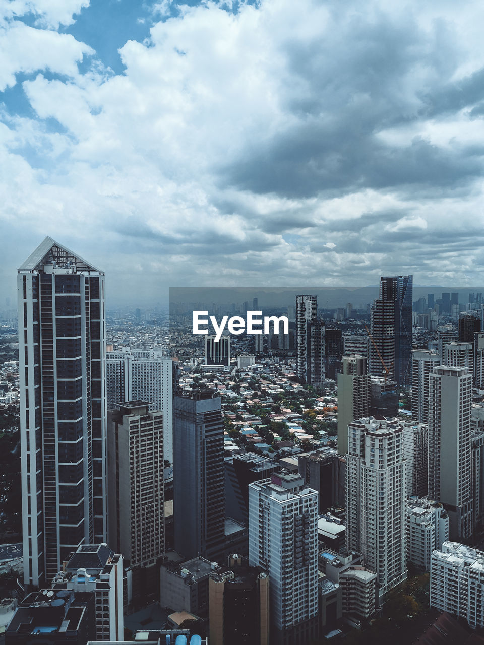 Aerial view of buildings in city against sky